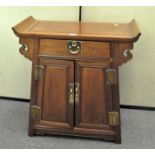 An Oriental hardwood cabinet, comprising a single drawer over a two door cupboard,