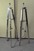 A pair of modern chrome standard lamps, of tapering tripod form,