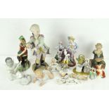 A collection of porcelain figures including a piano baby, Paragon jester,