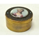A French circular gilt brass box inset with a portrait of a beauty painted on porcelain,