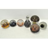 A group of six glass paperweights, to include a Caithness ink bottle and stopper,