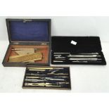 A late 19th/early 20th century boxed set of drawing instruments,