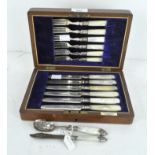 A set of six silver plated mother of pearl fruit knives and forks with silver collars,