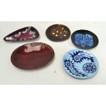 A collection of enamelled metal dishes, in abstract colourful designs,