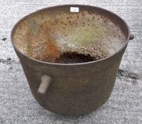 A metal cauldron, with three handles,