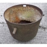 A metal cauldron, with three handles,