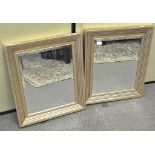 A pair of modern bevelled edge wall mirrors of rectangular form,