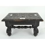 A 19th century oak stool, carved decoration throughout,