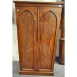 A Victorian mahogany two door wardrobe, with arched panels,