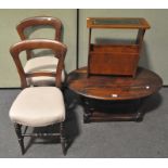 Two Victorian mahogany balloon back chairs together with a coffee-table and a newspaper rack,