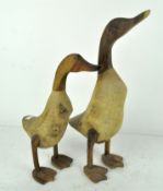 Two wooden sculptures of ducks,