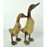 Two wooden sculptures of ducks,