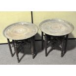 Two Middle Eastern brass topped folding tables,