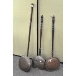 A group of three antique bed warming pans,