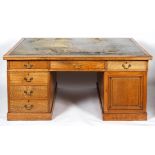 A large oak partner's desk, early 20th century, inset with green leather top,