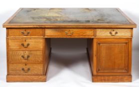 A large oak partner's desk, early 20th century, inset with green leather top,