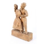 A carved wood sculpture of two dancers, a man and woman in 19th century dress,