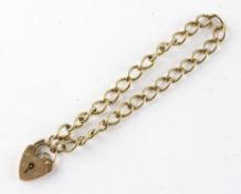 A yellow metal curb link bracelet with padlock clasp. Hallmarked 9ct gold, London, 1978.