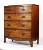 An early 19th century mahogany and inlaid bow fronted chest of drawers,