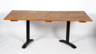 A kitchen table made from an oak door on metal legs,