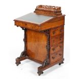 A Victorian walnut davenport, with hinged gallery, fitted interior,