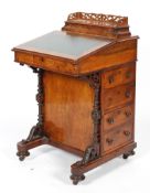 A Victorian walnut davenport, with hinged gallery, fitted interior,