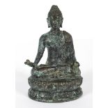 An Asian bronze model of a Buddha, 20th century cast seated cross-legged on a lotus flowers,