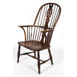An ash and elm Windsor chair, with crinoline stretcher, carved wheel splat, flanked by spindles,