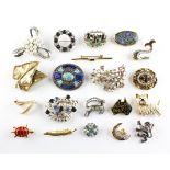 A collection of twenty costume brooches of variable designs.