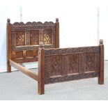 A Wood Carvers Guild Double Bed, the head and foot boards carved with floral and foliate decoration,