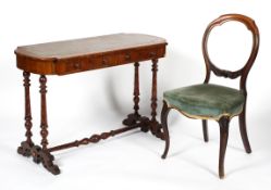 A Victorian mahogany writing table and a balloon back chair, late 19th century,