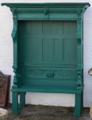 A large green painted garden seat, carved with acanthus and lion masks,