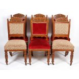 A set of six Edwardian oak dining chairs, with foliate carved back,