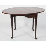 A George II style mahogany oval gate leg dining table, on tapering legs with pad feet,