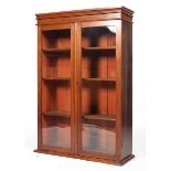 A Victorian mahogany bookcase with a moulded cornice above a pair of glazed doors,