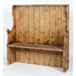A Victorian pine settle, with tongue and grooved back and scrolled arms,