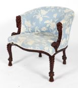 An Anglo Indian style tub chair, the upholstered back and serpentine seat on a rope carved frame,