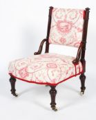 A Victorian walnut framed nursing chair, with floral upholstered back and seat,