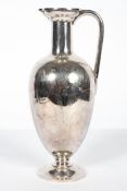 A silver plated wine ewer, early 20th century, engraved with swags of husks, with hinged cover,