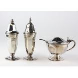 A silver George III style three piece cruet set, comprising: salt, pepper and mustard pot,