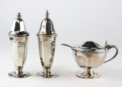 A silver George III style three piece cruet set, comprising: salt, pepper and mustard pot,