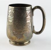 A late Victorian silver mug, highly engraved decoration throughout,