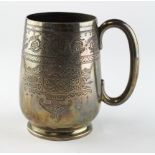 A late Victorian silver mug, highly engraved decoration throughout,