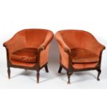 A matched pair of Edwardian tub chairs, each upholstered in salmon pink velvet, with scroll arms,