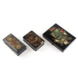 Two Victorian papier mache snuff or box/stamp boxes and hinged covers and another similar example