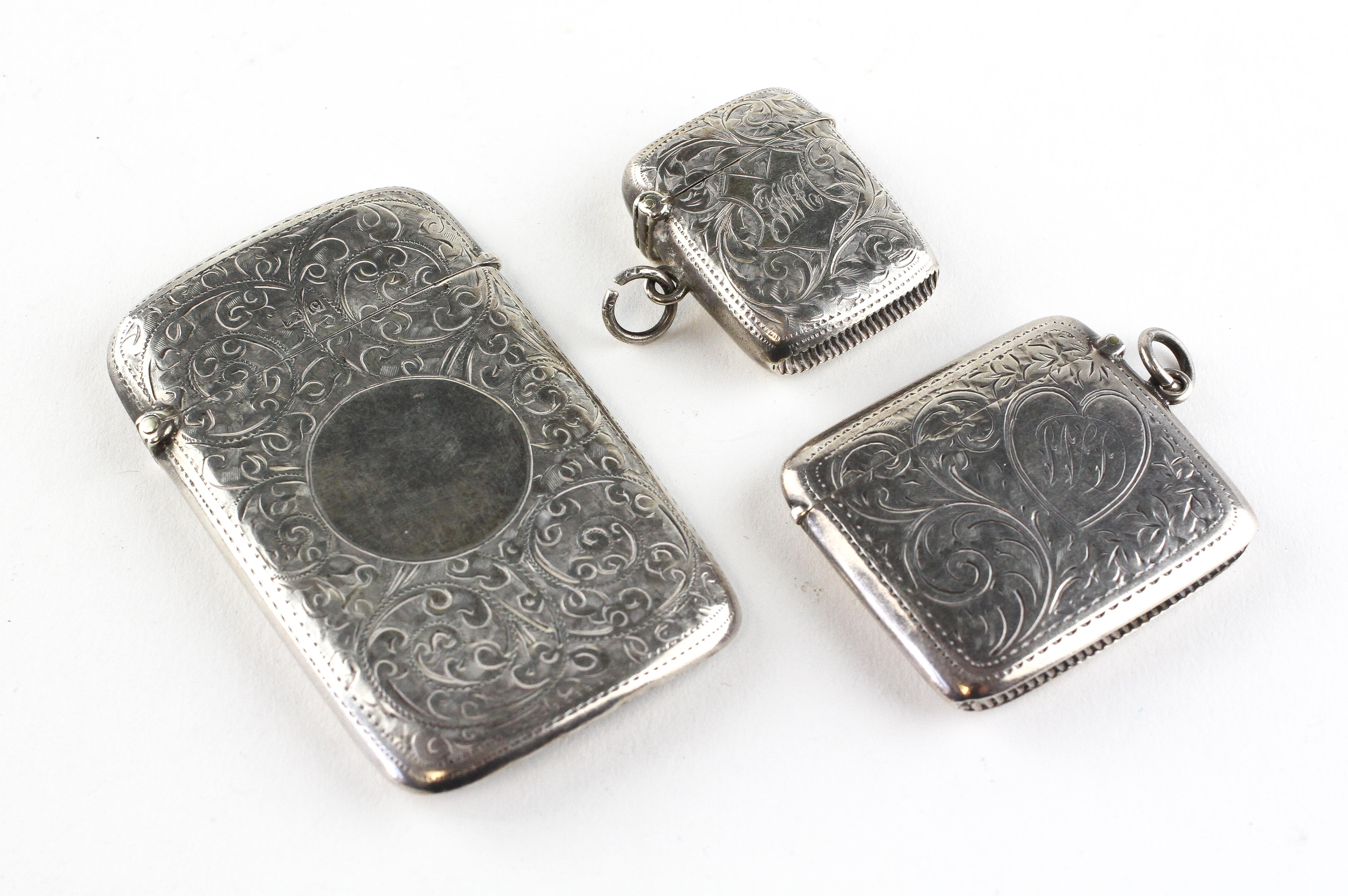 A silver card case and two silver vesta cases,