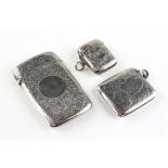 A silver card case and two silver vesta cases,