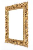 A Florentine style carved giltwood rectangular mirror, 20th century,