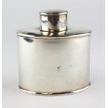 An Edwardian silver tea caddy of oval form, the borders with reeded decoration,