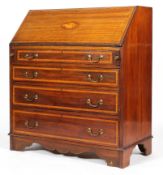 A Sheraton Revival mahogany and inlaid bureau, the fall front enclosing a fitted interior,